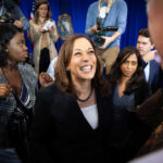 Harris Torches Trump – Tyrant Charge Lights Fuse Kamala Harris smiling among supporters with Maya Harris nearby