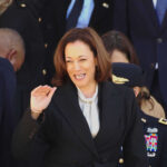 Mississippi Rally Backfires – Awkward Line Stops Harris Cold Kamala Harris waving in a crowd at a formal event