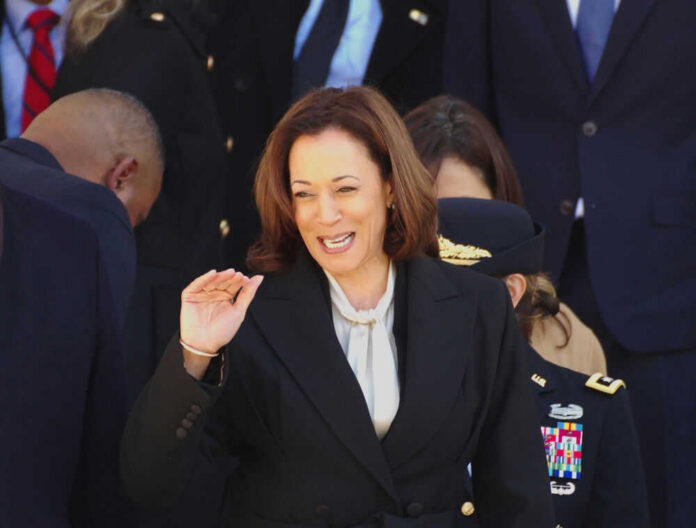 2492121505 Kamala Harris waving in a crowd at a formal event