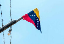 Floodgate To Freedom? Machado Explodes Venezuelan flag flying on a pole.