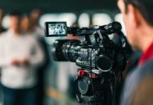 Video camera filming a group of people