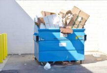 Packaging Ultimatum: Nationwide Redesign – Or Lose California Blue dumpster overflowing with cardboard boxes