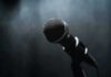 Clone Voice Breakthrough – Identity Line Crossed In Parliament Microphone on a stand against a dark blurred background