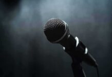 Clone Voice Breakthrough – Identity Line Crossed In Parliament Microphone on a stand against a dark blurred background