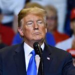Guilfoyle Ousted – Trump Draws Hard Line Donald Trump at a podium during a rally