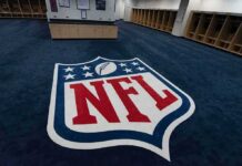 Paris Chaos, NFL Won’t Blink – Kickoff Still On NFL logo on the floor of an empty locker room