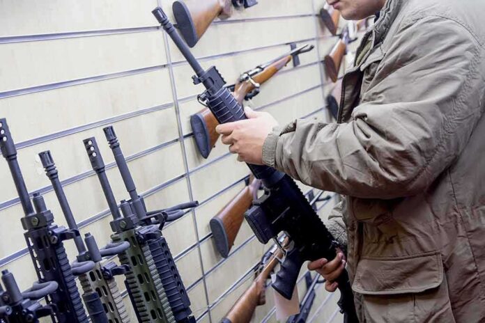 Person examining a black rifle in a gun store