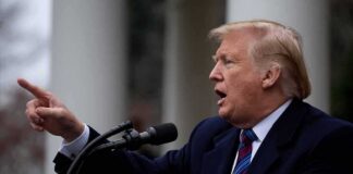 Donald Trump speaking at a podium and pointing