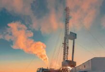 Peace Carrot Or Sanctions Backflip? Oil drilling rig at sunset releasing steam