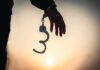Married At Midnight, Hanged At Dawn Hand with open handcuff in silhouette at sunset