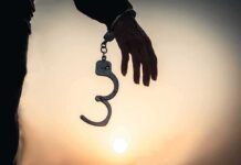 Married At Midnight, Hanged At Dawn Hand with open handcuff in silhouette at sunset