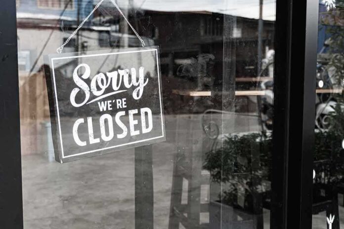 Closed sign hanging on a glass door