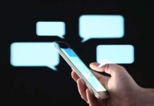 Unprotected Texts Map Bases And Bosses Hand holding smartphone with chat bubbles on dark background