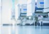 Hospital beds on wheels in a bright corridor
