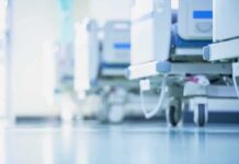 NHS U-Turn: Women-Only Wards Return – Finally Hospital beds on wheels in a bright corridor