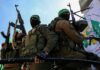 armed masked men in military gear holding rifles