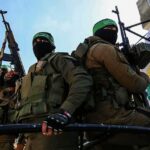 armed masked men in military gear holding rifles