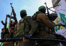 Crypto-Fueled Hamas Network Unmasked armed masked men in military gear holding rifles