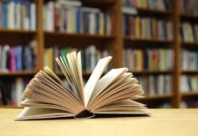 Purge Or Pay: Florida’s Book Crackdown Gets Teeth Open book on a table in a library