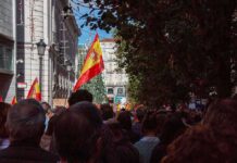 Spain’s Pushbacks Trigger EU Legal Clash Crowd with Spanish flags in a city street
