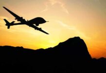 Pentagon Fast-Tracks Killer Drone Warheads Drone silhouette flying over mountains at sunset