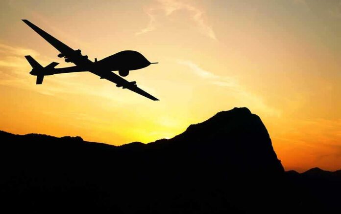 shutterstock_257107285 Drone silhouette flying over mountains at sunset
