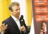 Rand Paul speaking with a microphone during an indoor event