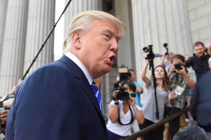 man in suit speaking to media outside a courthouse