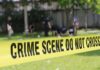 crime scene tape cordoning off a grassy area
