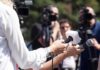 Trump Turns Tough Question Into Insult Brawl Reporters hold microphones during an outdoor press interview
