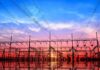 Dominion Hike Amid ‘Credits’ Hype Electrical substation with power lines at sunset