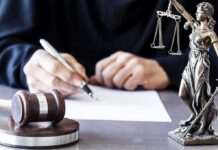 Ghost Rides Exposed – DOJ Slams $13M Grift Judge writing at desk with gavel and Lady Justice statue