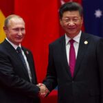 APEC Wildcard: Trump, Xi, Putin Float Chat two men in suits shaking hands